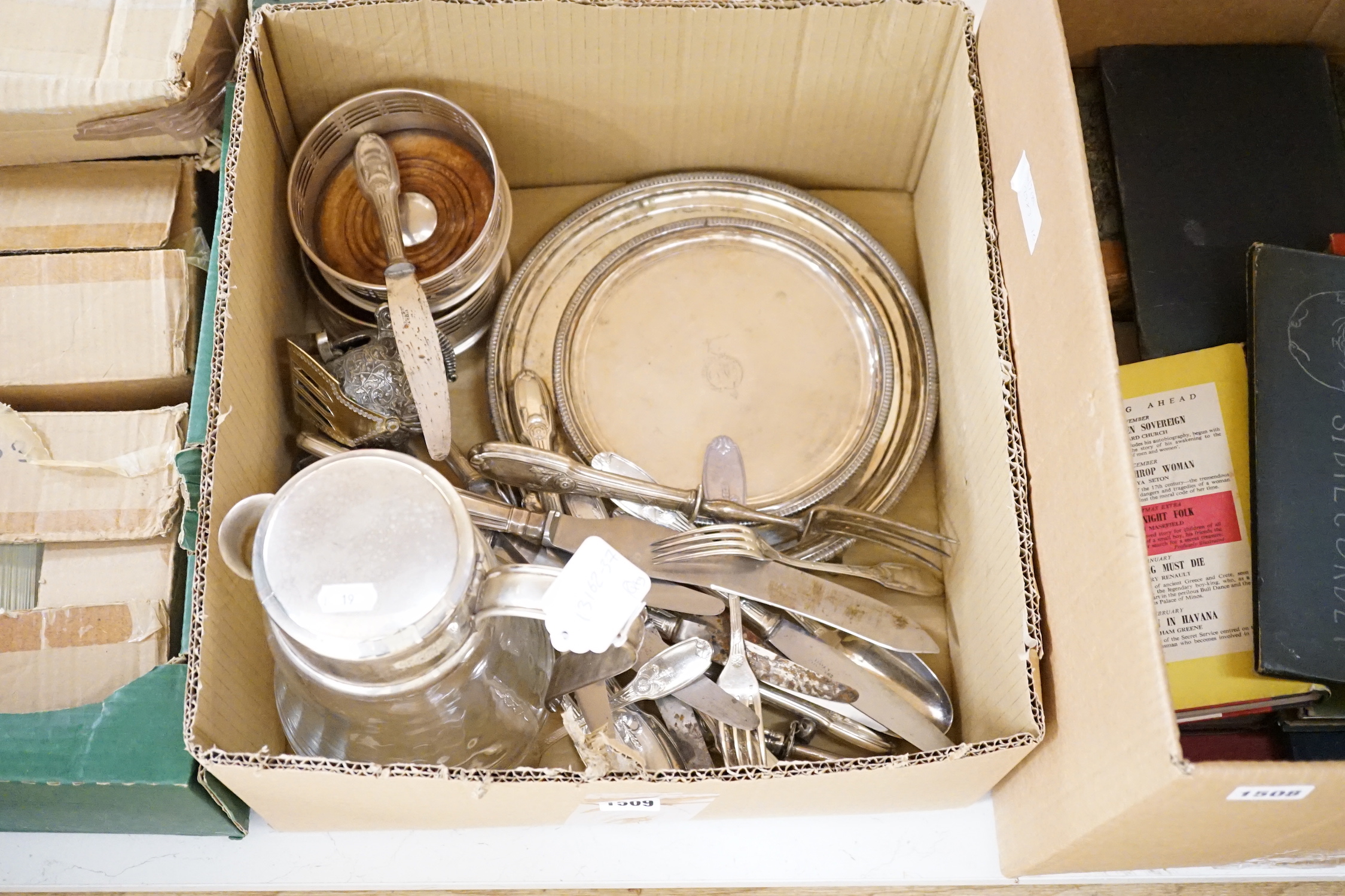 A quantity of assorted 19th century and later plated wares, including two salvers, mounted glass lemonade jug, a warming dish base, pair of wine coasters, rattle Knight's helmet lighter, Christofle and other cutlery, a s